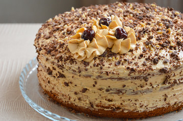 cream cake with chocolate chips and cream flowers