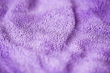 Fototapeta na wymiar Lilac delicate soft background of fur plush smooth fabric. Texture of purple soft fleecy blanket textile