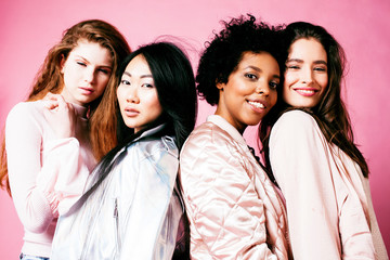 Obraz premium different nation girls with diversuty in skin, hair. Asian, scandinavian, african american cheerful emotional posing on pink background, woman day celebration, lifestyle people concept close up