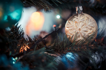 Christmas atmospheric background. A close-up fragment of a Christmas tree with toys, lights of gerland