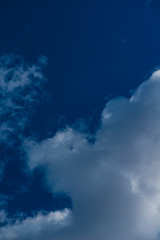 Fototapeta premium Puffy Cumulus Cloud On Vibrant, Deep Blue Sky