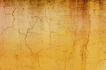 A dirty yellow background with cracks. Old plaster.