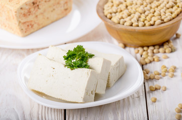 Soy Bean curd tofu on clay dish closeup. Non-dairy alternative substitute for cheese
