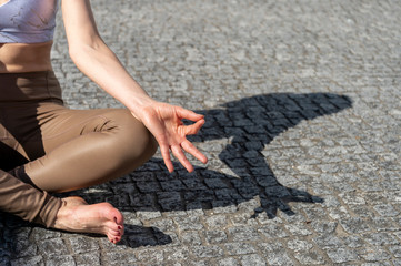 close up of a wwomans hand while practicing yoga, namaste hands.