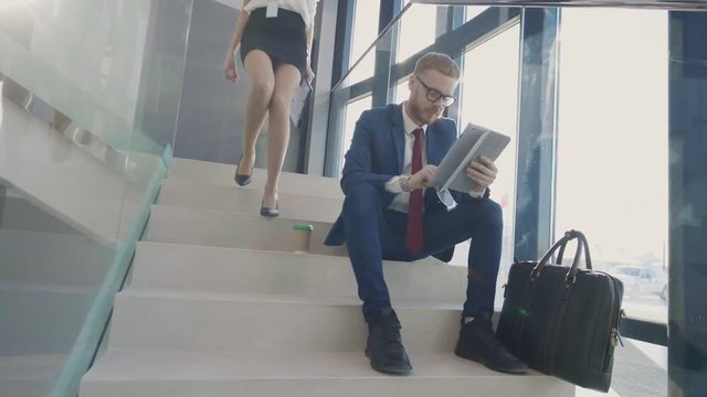 Man in suit sitting on stairs