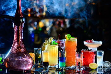 Fototapeta na wymiar Set of alcoholic cocktails in a hookah with beautiful smoke and space for text.