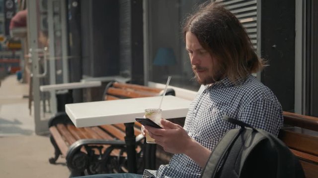 Man using the voice recognition on the phone, audio message ai speech helper, student male outdoor