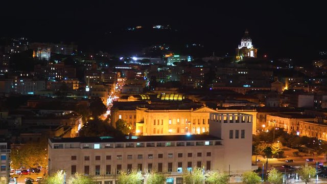 Panoramic top night view of the local buildings with lights, mountains in the beautiful city of Messina, Sicily, Italy in 4k