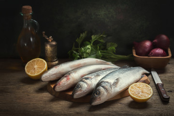 still life with fresh fish and ingredients for cooking
