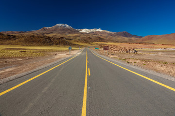 Fototapeta na wymiar Isolated road in the middle of Atacama desert
