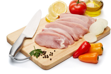 Raw turkey meat fillet and vegetables.
