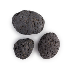 Set of 3 dark Canarian black lava stones isolated on white background top view.