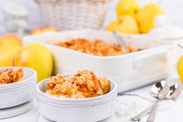 Homemade pie and yellow apples on a white table. Baking for breakfast with apples. Free space for text.
