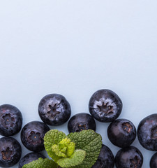 blueberry and mint on the clear gray background top view..