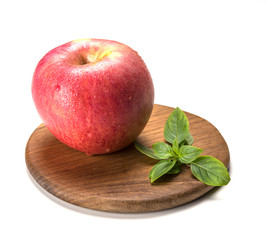 red apple wet wood board green sheet.