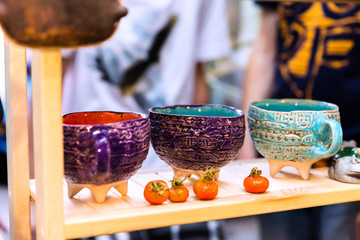 Handmade ceramics on the market. Mugs, plates