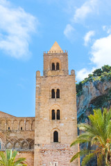 Fototapeta na wymiar Detail of beautiful Cefalu Cathedral in Cefalu, Sicily, Italy with blue sky. Roman Catholic basilica in Norman architectural style, part of UNESCO World Heritage Site