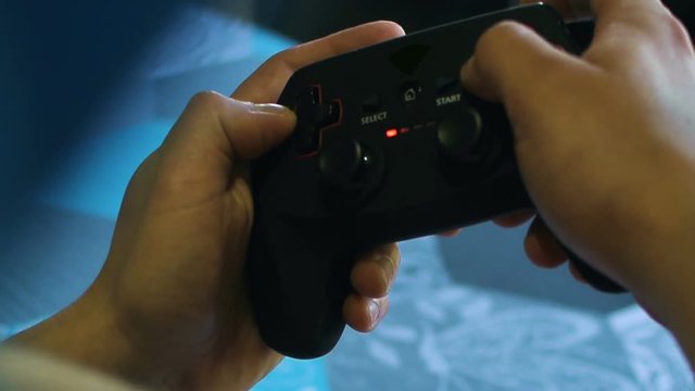 Game pad black playing game hold hands close up