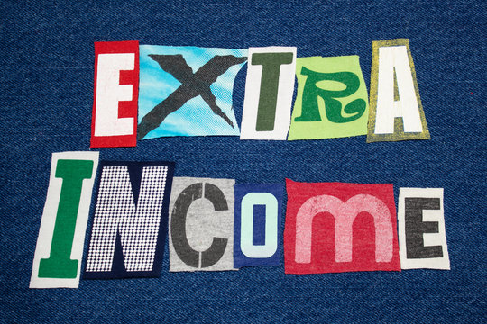 EXTRA INCOME text word colorful fabric collage on blue denim, side hustle, horizontal aspect