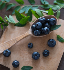 blueberry and mint, wooden spoon and board top view.