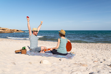 Happy man celebrating his engagement with his future wife on a mediterranean beach
