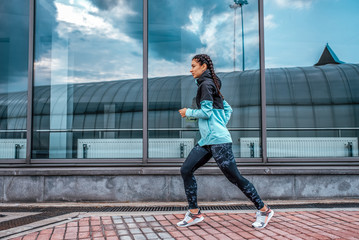 Obraz na płótnie Canvas Athlete girl running sports jogging training summer city. Concept fitness fresh air, active lifestyle workout. Free space. In morning evening motivation strength spirit, sportswear jacket leggings.