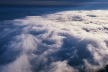 Fototapeta na wymiar above the clouds cloudscape. cloudy weather in the mountains. blue sky aerial view background.
