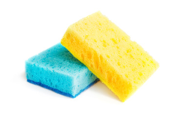 Colored sponges for washing dishes and other domestic needs. Yellow sponge lies on blue sponge at a slight angle. Isolate - obrazy, fototapety, plakaty