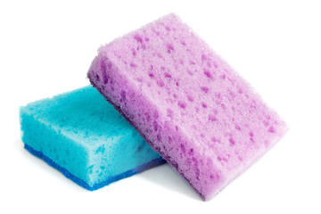 Colored sponges for washing dishes and other domestic needs. The purple sponge lies on the blue at...