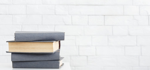 Stack of books on table at white background