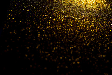 Gold abstract bokeh. Black background. Holyday concept