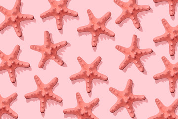 Fototapeta na wymiar Starfish pattern on pink . Summer minimalistic background. Top view, flat lay