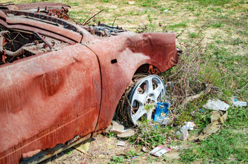 Burned car with burnt red rust