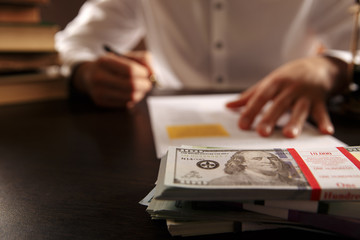 Closeup view of money and laywer concept on the desk. Male attorney behind