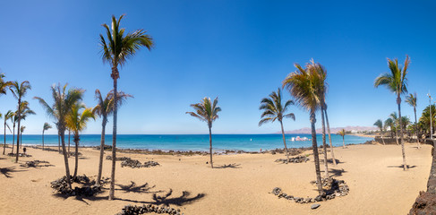 Sandy beach in Puerto del Carmen on Lanzarote - obrazy, fototapety, plakaty