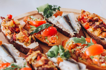 sandwich with trout, cherry tomatoes and lettuce. a plate of snacks.