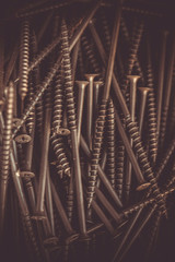 Detailed dark background and texture full frame of pile metal steel nails for construction of carpenter.