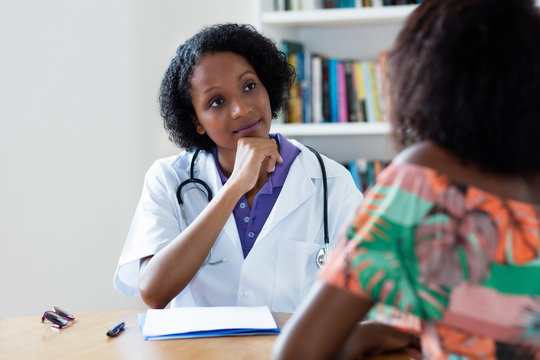 African american female doctor listening to patient