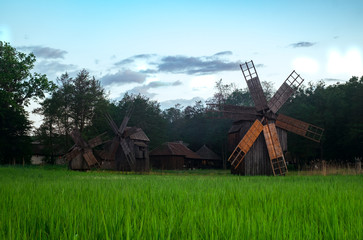 Fototapeta na wymiar Landscape with wind mills in Dumbrava lake, Astra Museum of Traditional Folk Civilization, Sibiu city, Romania