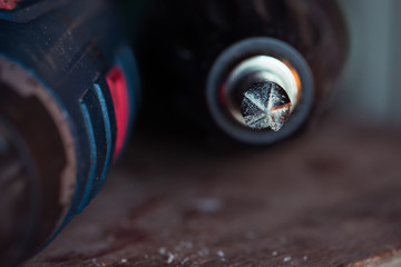 Cordless drill with drill bit after work.
