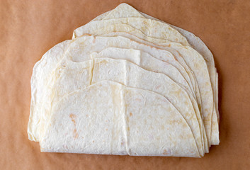 Thin pita bread on baking paper. Armenian pita bread close-up.