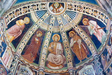COMO, ITALY - MAY 9, 2015: The fresco with the Jesus and saints (Peter, Mary, Baptist, Paul) in apse of church Basilica di San Abbondio by unknown artist "Maestro di Sant'Abbondio" (1315 - 1324).