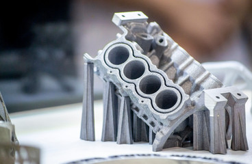 Man is holding object printed on metal 3d printer.
