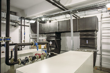 House heating system with many steel and plastic pipes, manometers and metal tubes and automated control equipment