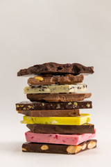 Various pieces of chocolate stacked to a tower.
