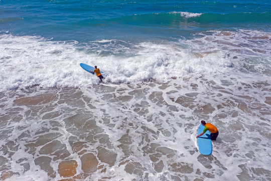 Vale Figueiras, Portugal - 25th may 2019: Aerial from surfers getting surfing lessons in the ocean