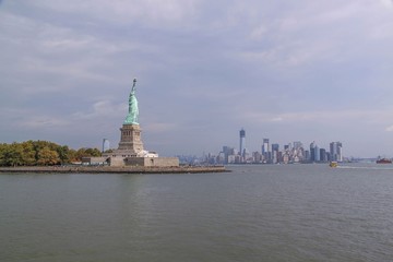 Beautiful view of famous Statue of Liberty and Manhattan on background.  Liberty Island in New York Harbor in New York. 