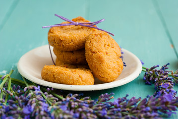 stack of lavender cookies on enamel plate, aged blue wooden table