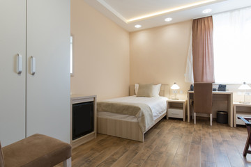 Naklejka na ściany i meble Hotel room interior,double bed beige bedroom