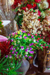 Plastic flowers and green leaves with exotic colors